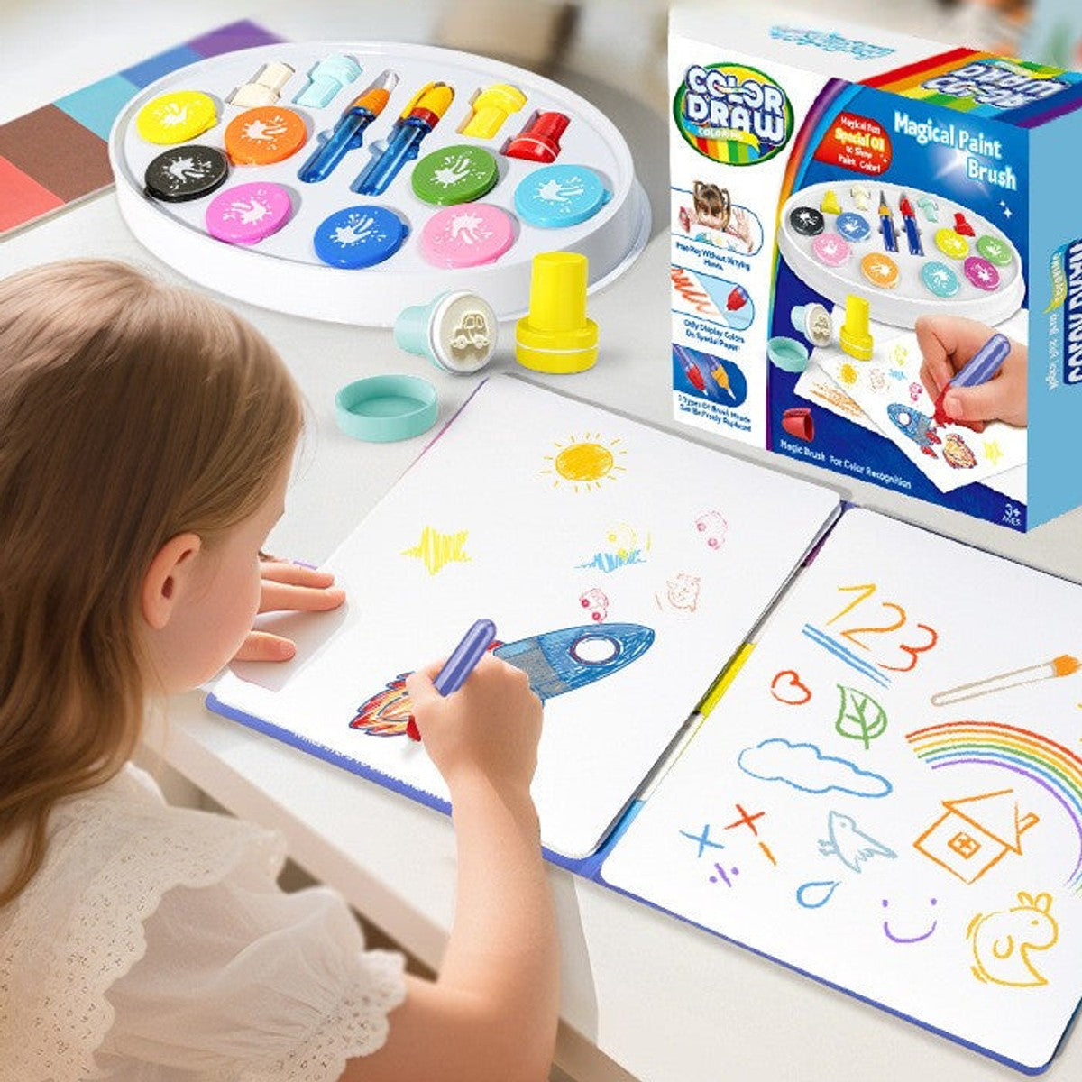 Child drawing with the magic brush set on the magnetic board