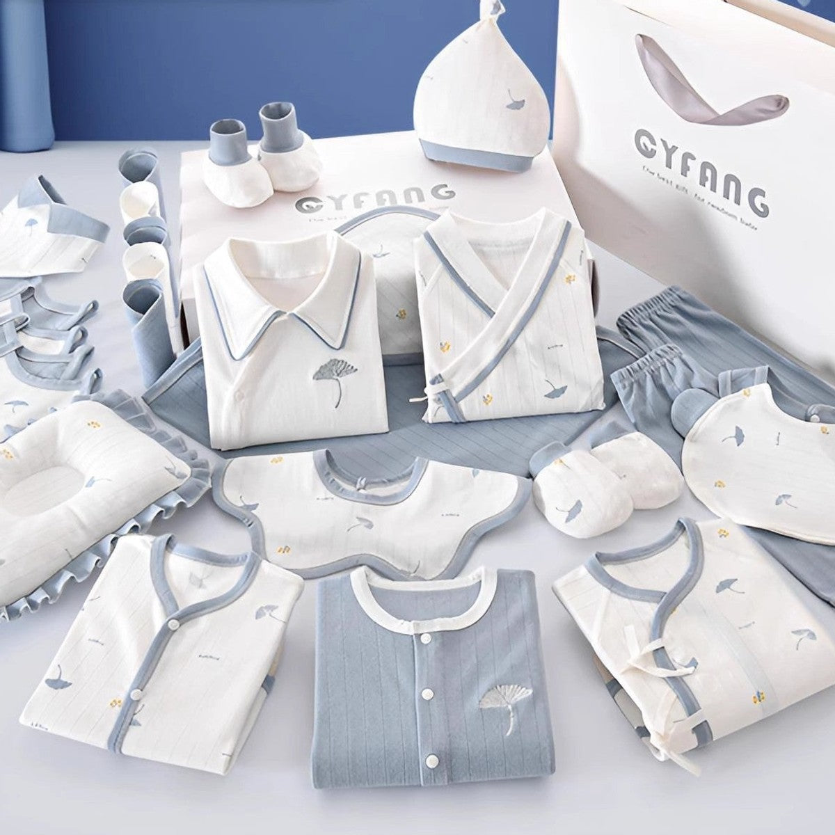 Newborn cotton clothing gift set laid out with gift box